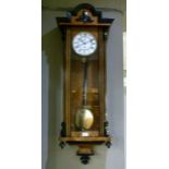 A 19th century parcel ebonised walnut wall clock with arched stepped pediment foliate carved and