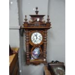 1920s walnut wall clock, the architectural pediment with set three urnular finials, the glazed