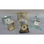 Seven mantel clocks, two carriage clock style, one mirrored, two glass, one brass cased, another