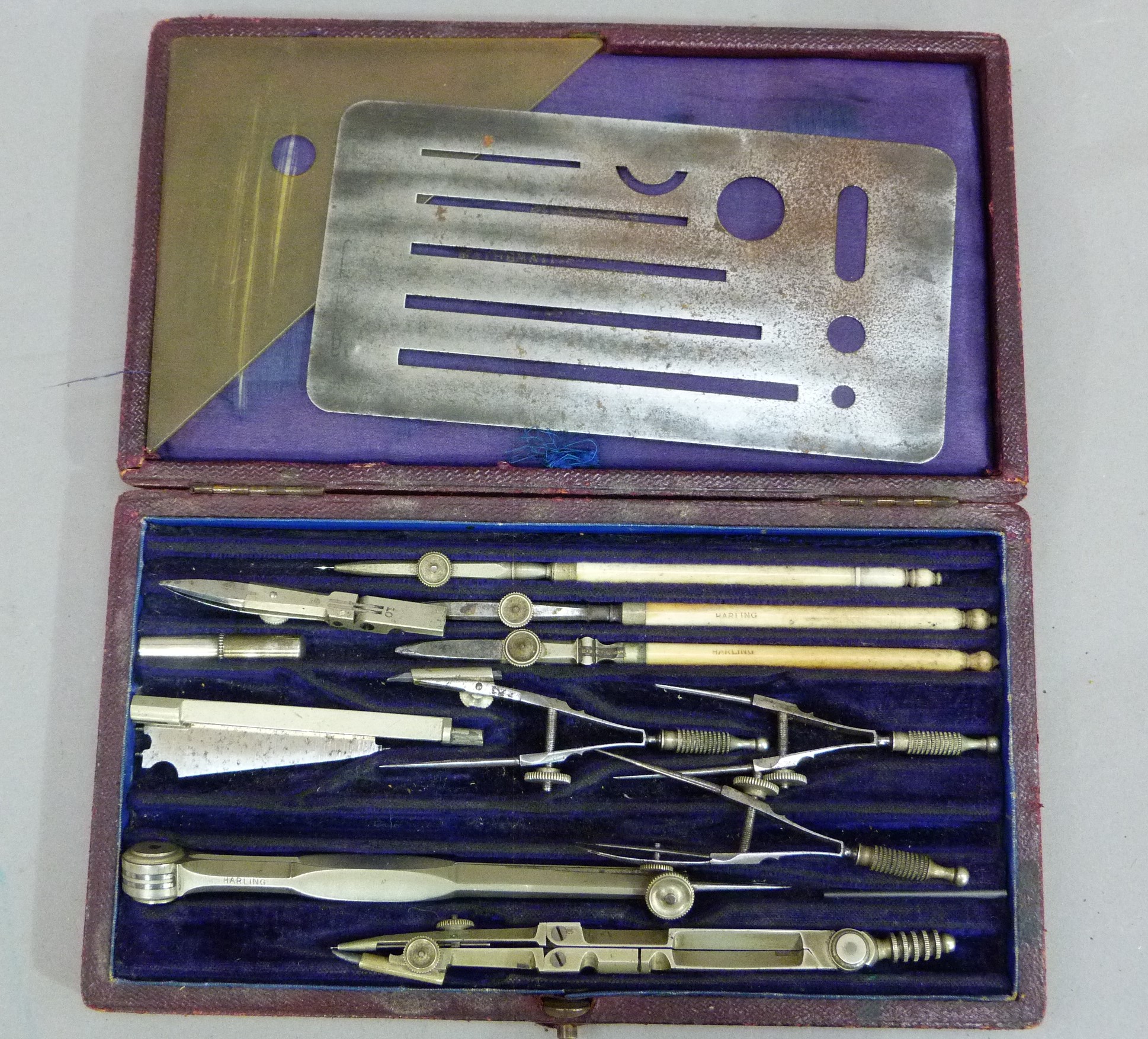 W H Harling a set drawing instruments contained in a purple velvet and silk lined red Morocco