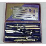 W H Harling a set drawing instruments contained in a purple velvet and silk lined red Morocco