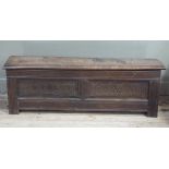 A 19th century oak kist of narrow proportions having a hinged single plank top above a twin panel