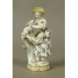 A Meissen figure of a shepherdess, tying a blue ribbon around a lamb's neck, circular base with gilt