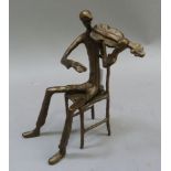 A modern bronze figure of a seated violinist, 23cm high