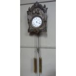 A Dutch wall clock by Renko with brass embossed face white enamelled dial with Roman numerals