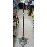 A brass telescopic standard lamp, the tapered column on a lobed socle, spreading circular base