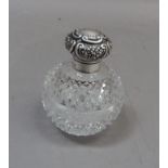 An Edwardian cut glass spherical scent bottle with silver collar and foliate and C-scroll embossed