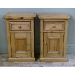 A pair of pine pot cupboards the rectangular tops with rounded front corners above geometric