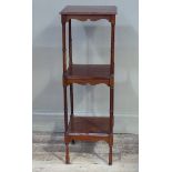 A reproduction mahogany three tier etagere on ring turned up rights, 31cm wide x 91cm high