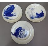 A set of three circular blue and white pottery plates each variously printed with cats at play, 25.