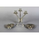 A Scandinavian stainless steel three light table candelabrum, 17.5cm high, together with a pair of