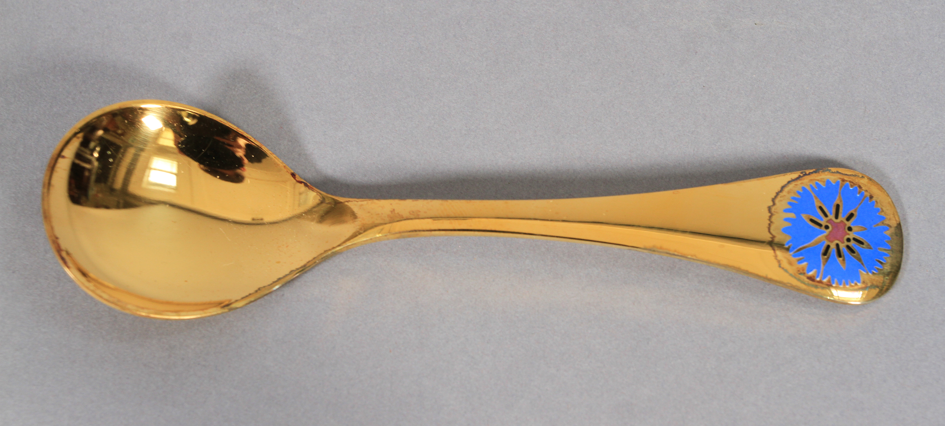 Georg Jensen, a .925 silver gilt year spoon for 1972 with cornflower motif in blue and aubergine