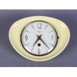 A Bentima 8 day pottery hanging wall clock with dished irregular yellow surround, cream dial with