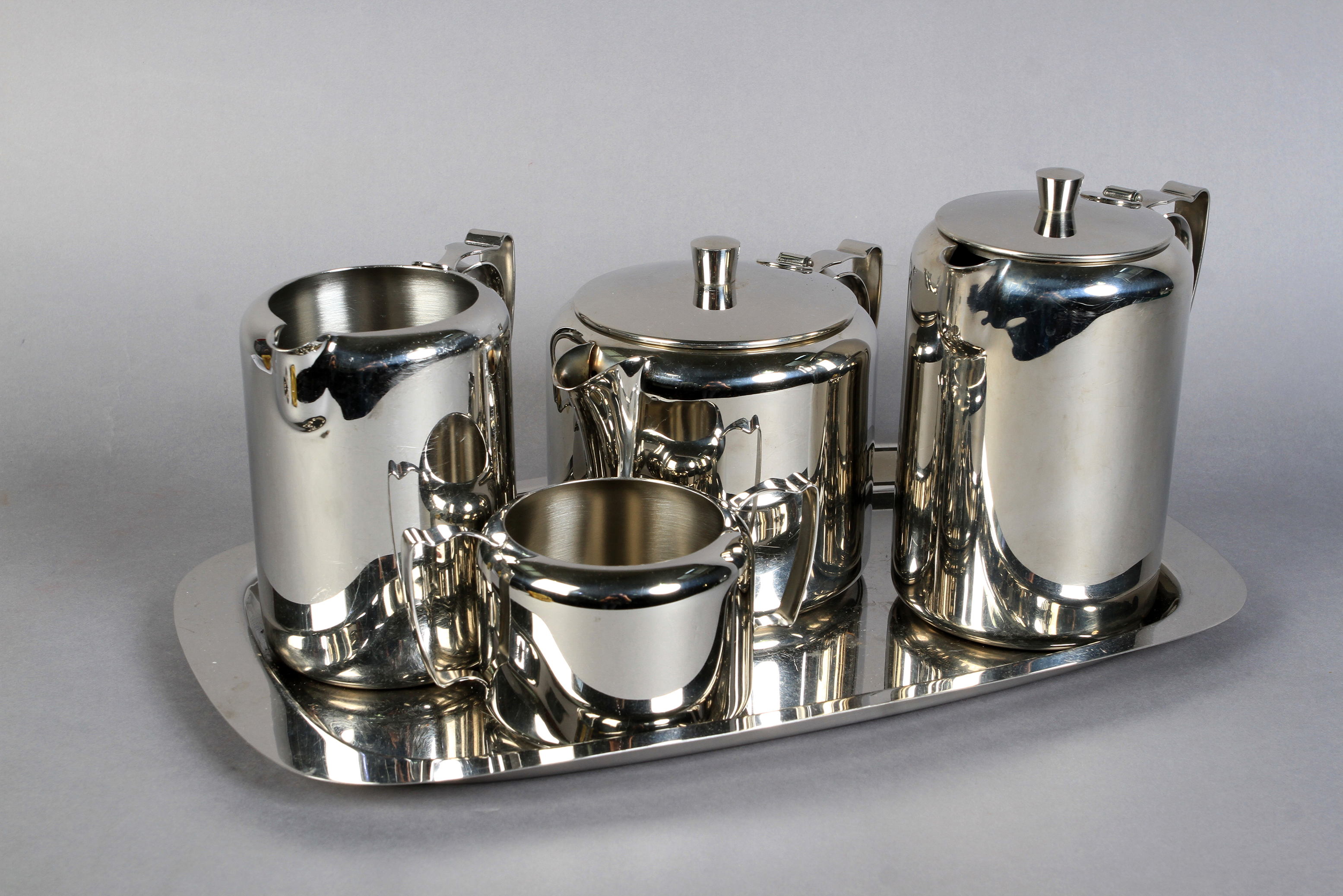 A five piece Old Hall stainless steel tea service comprising teapot, hot water, milk jug, sugar