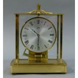 A Kieninger & Obergfell Kundo gilt metal and glass cased clock c.1960s, silvered dial with black