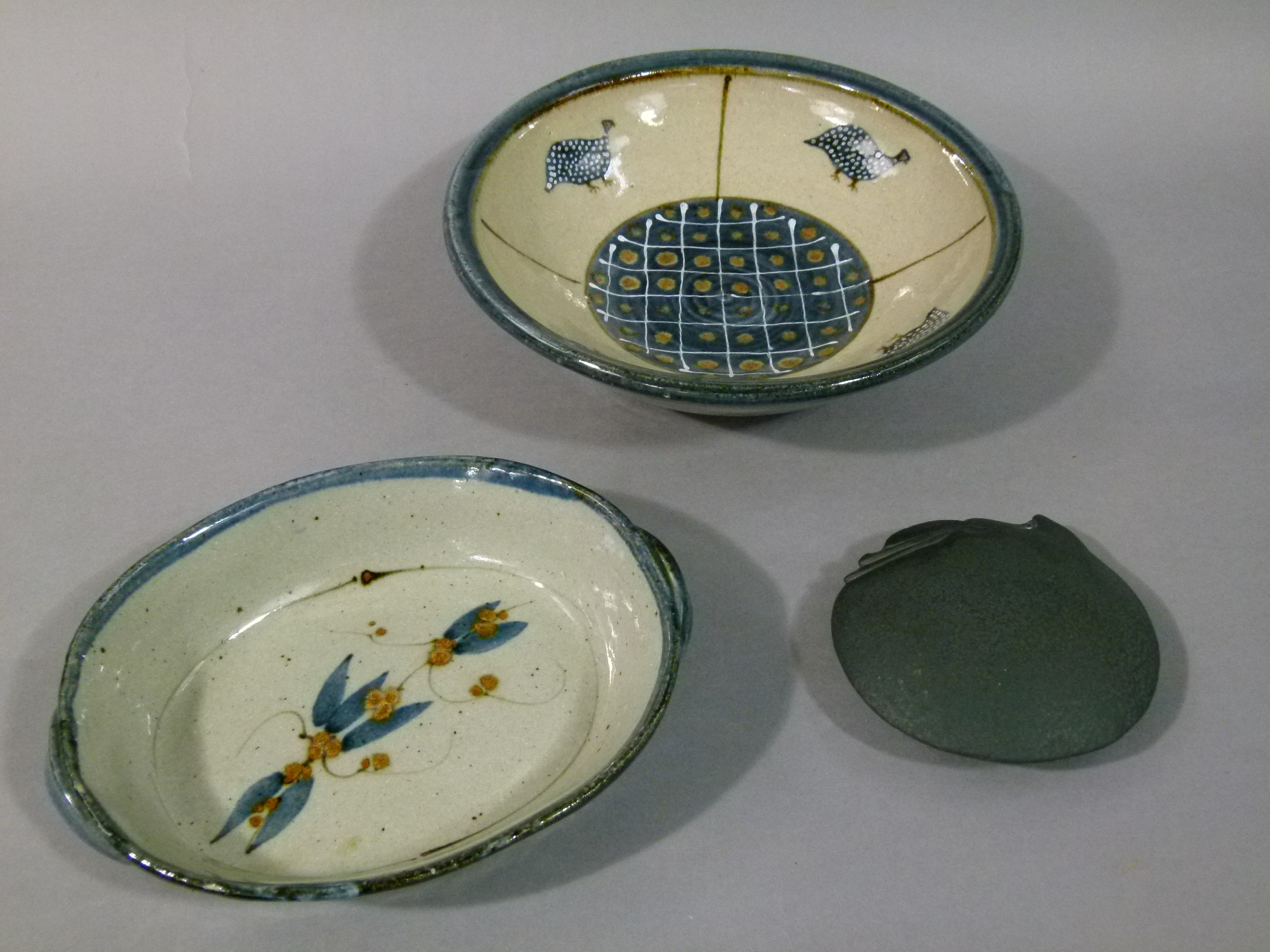 A stoneware bowl, painted with four guinea fowl in blue, brown and white, clear glaze and a two