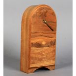 A marquetry mantel clock of arched form, the front inlaid in coloured woods with setting sun in a
