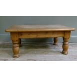 A reproduction pine coffee table, the rounded rectangular top above baluster turned legs, 90cm wide