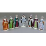 A set of seven porcelain figures of Henry VIII and his six wives, painted in colours, 21cm high,