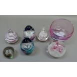 A Caithness glass paperweight, five other paperweights and a glass bowl with stylised flower head to