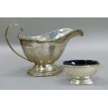 A George VI silver sauce boat with bead cast rim and flying scroll handle, 15.5cm wide by Walker &
