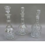 A pair of faceted baluster decanters with band of cut circles to the bodies, double ringed necks and