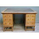 An oak twin pedestal desk, the top inset with an olive green tooled writing surface above a