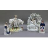 A Victorian Staffordshire flat back figure of a farmer and his cow, 22cm high; together with a