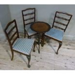 A set of three mahogany pierced ladder back single chairs with upholstered seats on leaf carved