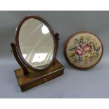 A Victorian walnut circular footstool with drop in circular top upholstered in floral gros point;