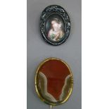 A 19th century portrait brooch on porcelain within an oval jet surround with base metal brooch back;