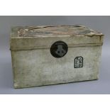 A small Chinese trunk, the hinged lid with the remnants of a Canadian Pacific luggage label, a