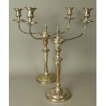 A pair of early 20th century plated on copper candelabra, of George III style, the twin scrolled