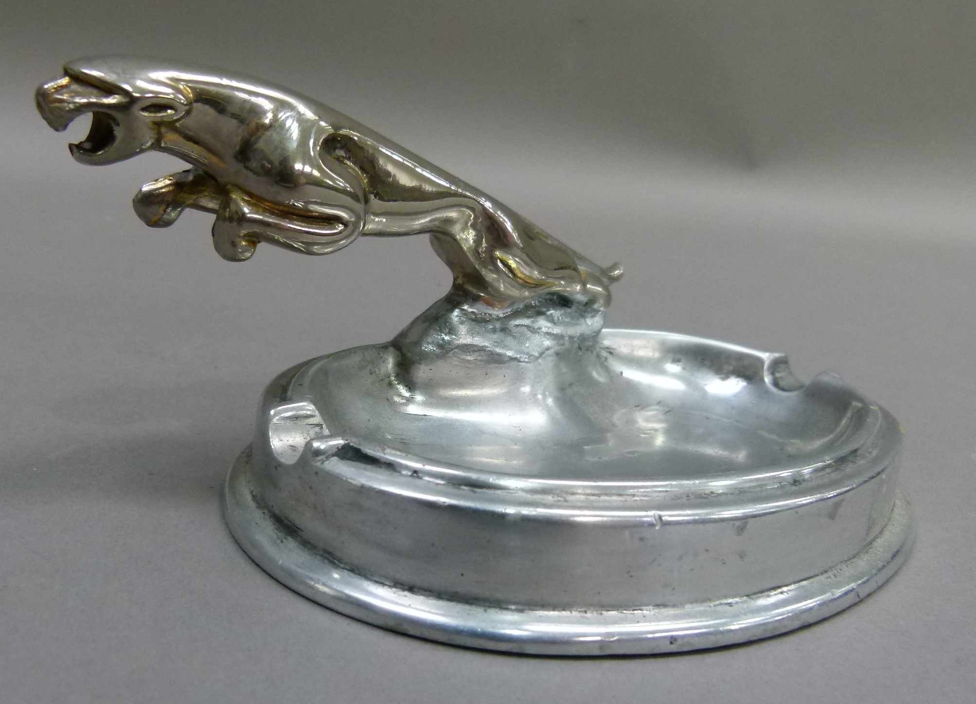 A reproduction white metal jaguar 'ashtray', 16cm wide