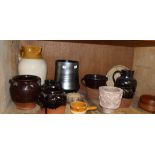 A quantity of dark treacle glazed terracotta pots and jugs; together with salt glazed large jug,