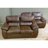 A pair of brown leather two seater sofas