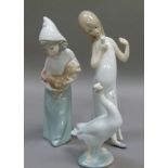 A Lladro figure of a young girl carrying a cockerel, 19cm high, printed mark in blue; another Lladro