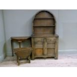 An oak veneered arched dresser fitted with two short drawers and panelled cupboards, an oak drop