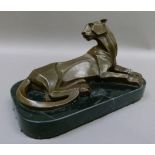 A reproduction bronze model of a panther on black marble base, 29cm wide