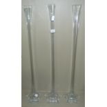 Three clear glass lily vases, 80cm high