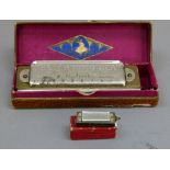 A Hohner chromonica, boxed, together with a miniature Hohner harmonica, boxed (2)