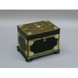 A Victorian black papier mâché tea caddy, the hinged lid with shaped floral filled cartouche on a