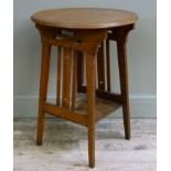 A Liberty style oak occasional table, the circular top above pierced panel and vertical rails,