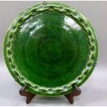 A green glazed platter with applied pinched border, the reverse impressed PBR, 30cm diameter