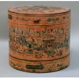 A Sino Tibetan? red papier mâché cylindrical lidded food container decorated overall with figures