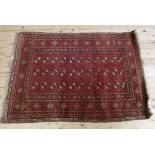 A Bokhara rug, red ground with three rows of eleven octagonal guhls, multi guard striped, fringed,