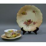 A Royal Worcester shaped circular cabinet plate, painted with floral sprays on a shaded apricot