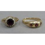 Two gem set gold rings, one 9ct the other indistinct marks, one set three circular garnets, the