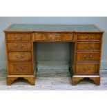 A reproduction mahogany desk in George III style the rectangular top with serpentine shaped