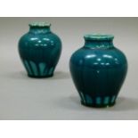 A pair of Linthorpe baluster vases decorated with a turquoise blue streaky glaze, 8cm high,